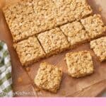 Pinterest graphic of flapjacks on a parchment lined serving board with a few pieces cut out.
