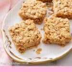 Pinterest graphic of a platter of flapjacks with a bowl of berries in the background.