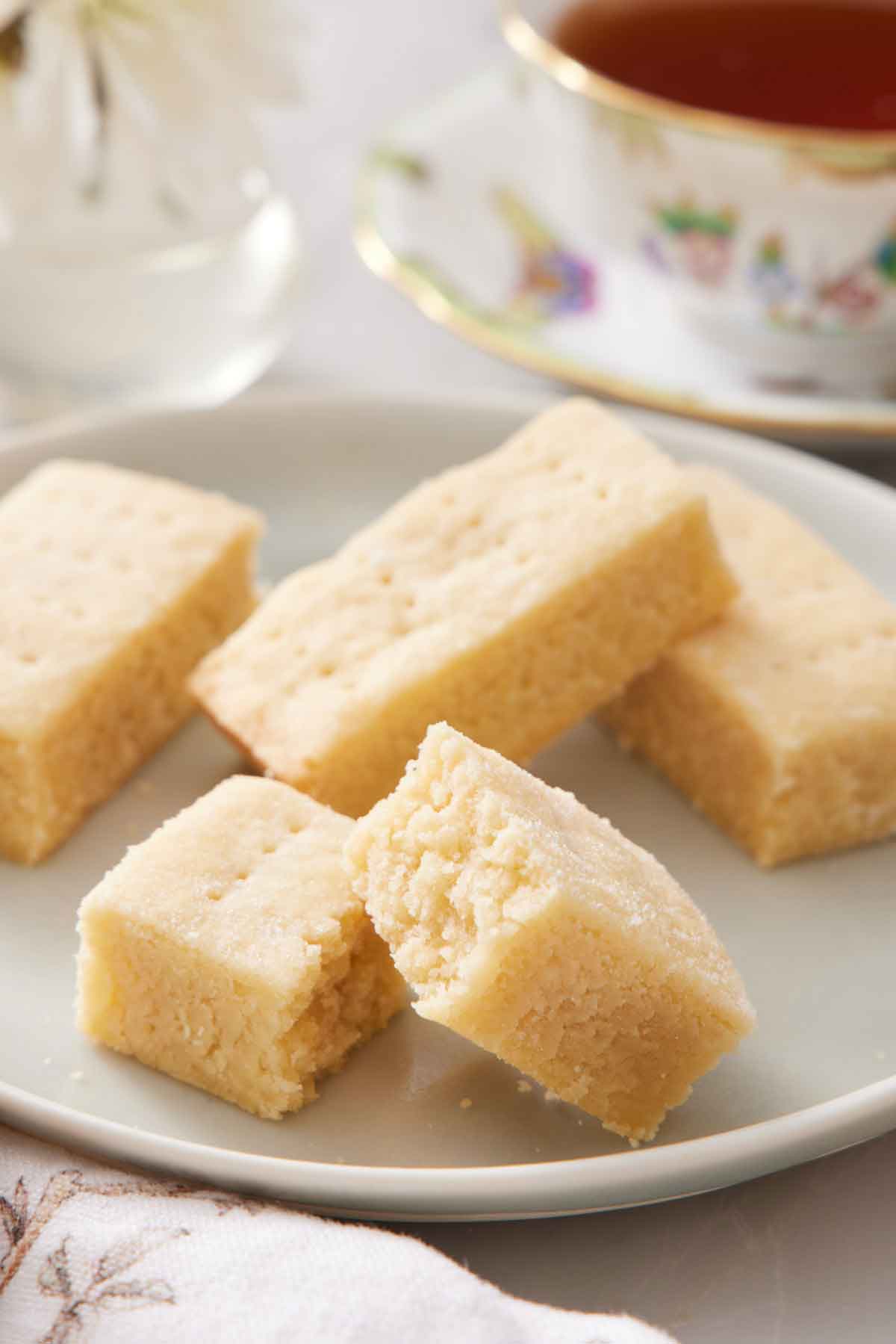 A plate with shortbread with one piece broken in half.